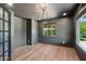 Stylish home office features grey walls, light hardwood floors, and a modern chandelier at 20 W Pasadena Ave, Phoenix, AZ 85013