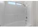 This bathroom features a bright white tub and shower with a hand-held showerhead at 2028 W Alice Ave, Phoenix, AZ 85021
