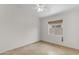 This room features tile floors, a ceiling fan, and a window with wood-look blinds at 2028 W Alice Ave, Phoenix, AZ 85021