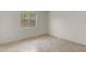 This room features tile floors, neutral walls, and a window overlooking the backyard at 2028 W Alice Ave, Phoenix, AZ 85021