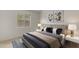 This bedroom features stylish decor and art, and also a window and carpeting at 2028 W Alice Ave, Phoenix, AZ 85021