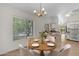 The dining area features a modern light fixture and a view to the kitchen at 2028 W Alice Ave, Phoenix, AZ 85021