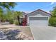 Charming single-story home with a two-car garage, xeriscape landscaping, and mature desert plants at 2028 W Alice Ave, Phoenix, AZ 85021