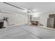 The two car garage features an epoxy floor, shelving, and work bench at 2028 W Alice Ave, Phoenix, AZ 85021