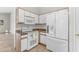 Bright kitchen features white cabinets, modern appliances, and stone countertops at 2028 W Alice Ave, Phoenix, AZ 85021
