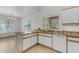 Bright kitchen features white cabinets, granite countertops and island with sink at 2028 W Alice Ave, Phoenix, AZ 85021