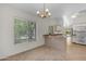 Bright kitchen features granite countertops, tile flooring, modern lighting, and a lovely window at 2028 W Alice Ave, Phoenix, AZ 85021