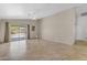Bright and spacious living room with tile floors, vaulted ceiling, and sliding glass doors at 2028 W Alice Ave, Phoenix, AZ 85021