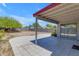 Covered patio with tile flooring overlooking a spacious backyard with block fencing at 2028 W Alice Ave, Phoenix, AZ 85021