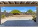 Covered patio provides a view of a large backyard with desert landscaping and block fencing at 2028 W Alice Ave, Phoenix, AZ 85021