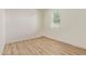 A bright, empty bedroom featuring wood flooring and a window with blinds, creating a clean space at 22876 E Via Del Sol --, Queen Creek, AZ 85142