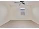 An empty bedroom with neutral tile floors, a ceiling fan, and a window with natural light at 22876 E Via Del Sol --, Queen Creek, AZ 85142