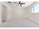 Bedroom with neutral carpet, ceiling fan, and large window at 22876 E Via Del Sol --, Queen Creek, AZ 85142