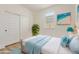 Well-lit bedroom with modern décor, bright pillows, and a closet that adds functionality at 22876 E Via Del Sol --, Queen Creek, AZ 85142