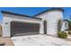 Attractive home showcasing a spacious driveway, two-car garage, and well-maintained landscaping at 22876 E Via Del Sol --, Queen Creek, AZ 85142