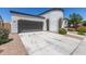 Attractive home showcasing a spacious driveway, two-car garage, and well-maintained landscaping at 22876 E Via Del Sol --, Queen Creek, AZ 85142