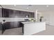 Elegant kitchen features dark cabinets, white countertops, and stainless steel appliances at 22876 E Via Del Sol --, Queen Creek, AZ 85142
