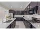 Sleek kitchen boasts stainless steel appliances, dark cabinets, and a functional layout at 22876 E Via Del Sol --, Queen Creek, AZ 85142