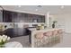 Inviting kitchen with island seating, dark cabinetry, and stainless steel appliances at 22876 E Via Del Sol --, Queen Creek, AZ 85142