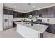 Modern kitchen features a spacious island, stainless steel appliances, and dark cabinetry at 22876 E Via Del Sol --, Queen Creek, AZ 85142