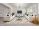 Stylishly staged living room featuring white sofas, modern lighting, and media center at 22876 E Via Del Sol --, Queen Creek, AZ 85142