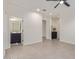 Spacious living room with tiled flooring that leads to a bathroom and other rooms at 22876 E Via Del Sol --, Queen Creek, AZ 85142