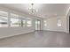 Open-concept living space with modern chandelier, tile floors, and bright, natural light at 22876 E Via Del Sol --, Queen Creek, AZ 85142