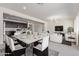Bright living space with modern kitchen, white dining set, and white sofas at 22876 E Via Del Sol --, Queen Creek, AZ 85142