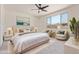Beautifully staged primary bedroom with plush bedding, ceiling fan, and lots of natural light at 22876 E Via Del Sol --, Queen Creek, AZ 85142