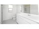 Bright bathroom with a white vanity, a toilet, a shower with a glass door, and a large mirror at 24245 W Hidalgo Ave, Buckeye, AZ 85326