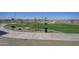 Well-maintained dog park with a grassy area, seating, and waste disposal for the community's pets at 24245 W Hidalgo Ave, Buckeye, AZ 85326