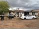 Backyard view with vehicles and a detached garage or storage shed at 25 W Illini St, Phoenix, AZ 85041