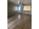 Bright living room featuring tile flooring, a ceiling fan, and natural light from the window at 25 W Illini St, Phoenix, AZ 85041