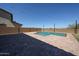 This expansive backyard features a sparkling pool with elegant string lights, creating a magical outdoor oasis at 25051 N 140Th Dr, Surprise, AZ 85387