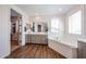 Bathroom featuring a large soaking tub, double sink vanity, and modern finishes providing a relaxing retreat at 25051 N 140Th Dr, Surprise, AZ 85387