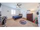A sports themed bedroom featuring a ceiling fan, desk, closet, and a twin size bed at 25051 N 140Th Dr, Surprise, AZ 85387