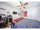 Relaxing bedroom features a ceiling fan, workspace, and patriotic decor at 25051 N 140Th Dr, Surprise, AZ 85387
