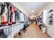 This large walk-in closet offers ample storage with shelving and hanging space for optimal organization at 25051 N 140Th Dr, Surprise, AZ 85387