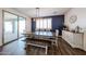Inviting dining room boasts wood floors, rustic table with bench, modern lighting and stylish storage at 25051 N 140Th Dr, Surprise, AZ 85387