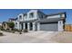 Spacious two-story home with an attached two-car garage and neatly maintained desert landscaping at 25051 N 140Th Dr, Surprise, AZ 85387