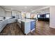 Contemporary kitchen showcasing an island, grey cabinets, and open layout to the living space at 25051 N 140Th Dr, Surprise, AZ 85387