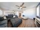 Spacious living room with wood look floors, blue sofas and a kitchen view at 25051 N 140Th Dr, Surprise, AZ 85387