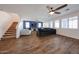 Spacious living room with wood look floors, blue accent wall and plenty of natural light at 25051 N 140Th Dr, Surprise, AZ 85387