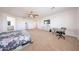 A spacious main bedroom featuring a ceiling fan, carpeted floors and space for an office at 25051 N 140Th Dr, Surprise, AZ 85387