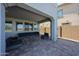 Enjoy the covered patio with comfortable seating, creating a perfect outdoor retreat for relaxation and entertainment at 25051 N 140Th Dr, Surprise, AZ 85387