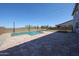 This stunning backyard has a refreshing pool, perfect for hot days, with a trampoline adding entertainment at 25051 N 140Th Dr, Surprise, AZ 85387