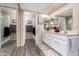Bright bathroom featuring white cabinets, stylish mirrors, and walk in shower with glass door at 25225 S Glenburn Dr, Sun Lakes, AZ 85248