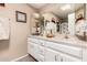 Well-lit bathroom featuring a granite countertop, double mirrors and a sink with silver fixtures at 25225 S Glenburn Dr, Sun Lakes, AZ 85248
