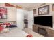 Cozy bedroom featuring a flat screen television, sports memorabilia and a peek at the dining area at 25225 S Glenburn Dr, Sun Lakes, AZ 85248