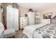 Spacious bedroom with soft carpet, white furniture, and an en-suite bathroom view for added convenience at 25225 S Glenburn Dr, Sun Lakes, AZ 85248